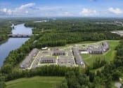 Thumbnail 68 of 70 - an aerial view of a campus with a body of water