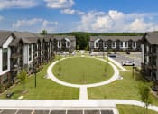 Thumbnail 63 of 70 - an aerial view of an oval lawn in front of apartment buildings