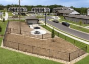 Thumbnail 57 of 70 - an aerial view of a fenced in park with a basketball court