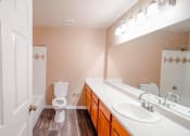 Thumbnail 31 of 69 - a bathroom with a toilet and a sink and a mirror
