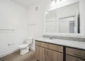 Thumbnail 8 of 24 - a bathroom with a sink and a toilet and a mirror