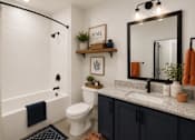 Thumbnail 15 of 40 - A bathroom with a white toilet, a white sink, and a white bathtub.