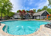 Thumbnail 1 of 17 - a large pool with a house in the background
