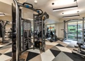 Thumbnail 30 of 58 - a spacious fitness center with cardio machines and weights