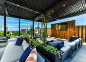 Thumbnail 44 of 58 - a roof deck with couches and a tv