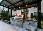 Thumbnail 42 of 58 - a large outdoor kitchen with stainless steel appliances and a pergola