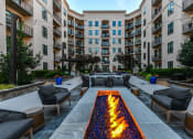 Thumbnail 40 of 58 - an outdoor patio with a firepit and lounge chairs