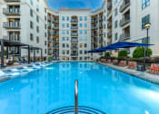 Thumbnail 36 of 58 - a large swimming pool in front of an apartment building