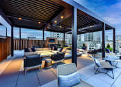 Thumbnail 48 of 58 - a roof top patio with furniture and a fireplace