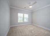 Thumbnail 51 of 54 - an empty living room with a ceiling fan and a window