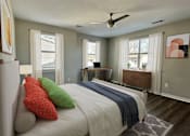 Thumbnail 13 of 48 - A bedroom with a large bed and a ceiling fan.