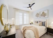 Thumbnail 6 of 38 - Panama City Beach, FL, Apartments with In-Unit Washer and Dryer - Vintage Lake Powell - Bedroom With White Bed, Layered Pillows, Two Nightstands With Lamps, Ceiling Fan, And Sheer Curtains.