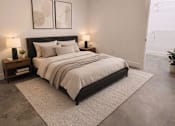 Thumbnail 10 of 33 - A bedroom with a large bed and a ceiling fan.