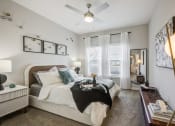 Thumbnail 16 of 22 - a bedroom with a large bed and a ceiling fan