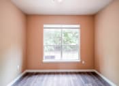 Thumbnail 45 of 69 - an empty room with a large window and wooden floors