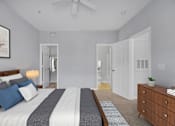 Thumbnail 14 of 29 - A bedroom with a bed, dresser, and mirror.