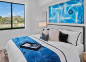 Thumbnail 21 of 78 - a bedroom with a white bed and a blue blanket at Altis Blue Lake, Florida, 33467