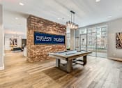 Thumbnail 4 of 30 - A room with a pool table and a brick wall with a sign that says The Union.