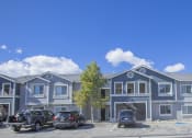 Thumbnail 6 of 43 - a large blue building with cars parked in front of it