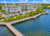 Thumbnail 40 of 45 - A large building with a dock in front of it.
