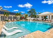 Thumbnail 29 of 45 - A pool with a white building in the background.
