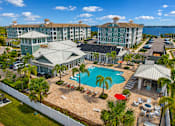 Thumbnail 37 of 45 - A resort with a pool and palm trees.