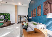 Thumbnail 23 of 54 - A modern waiting room with a green chair and a green wall with a sign that says