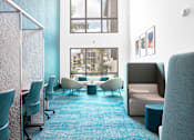 Thumbnail 3 of 29 - A room with blue carpet and white chairs.