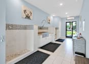 Thumbnail 27 of 37 - A bathroom with a white tub and a white sink.