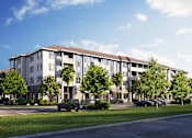 Thumbnail 16 of 19 - A modern apartment building with a parking lot in front.