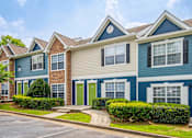 Thumbnail 17 of 18 - A row of houses with blue and beige siding.
