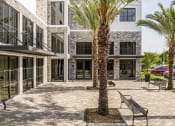 Thumbnail 20 of 22 - a courtyard with benches and palm trees in front of a building  at Leena Plantation, Florida, 33322