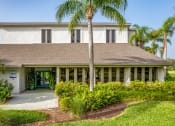 Thumbnail 1 of 34 - a house with palm trees in front of it at L'Estancia, Sarasota, FL
