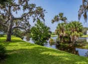 Thumbnail 29 of 34 - a view of a body of water with trees and a house at L'Estancia, Florida, 34231