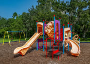 Thumbnail 22 of 34 - a playground with a slide and other playground equipment at L'Estancia, Sarasota, FL, 34231