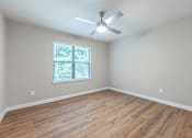 Thumbnail 7 of 30 - A room with a ceiling fan and a window with blinds.