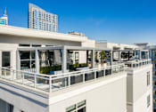 Thumbnail 28 of 36 - A white building with balconies overlooks a cityscape.