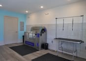 Thumbnail 22 of 24 - a gym with a treadmill and a ironing board