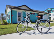 Thumbnail 17 of 24 - a white bike parked in front of a blue house