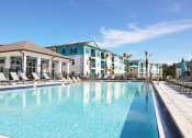 Thumbnail 14 of 24 - a large swimming pool with apartments in the background
