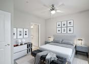 Thumbnail 7 of 36 - A bedroom with a bed, nightstands, and pictures on the wall.