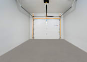 Thumbnail 24 of 24 - A white room with a grey floor and a white door.