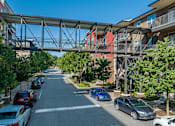 Thumbnail 45 of 46 - a bridge over a street with cars parked under it