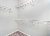 Thumbnail 22 of 24 - Empty shelves in a white room.