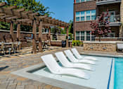 Thumbnail 37 of 46 - our apartments have a resort style pool with lounge chairs