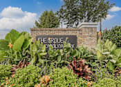 Thumbnail 36 of 41 - A sign that says "The Orchard" is surrounded by plants.
