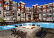 Thumbnail 19 of 46 - Dog-Friendly Apartments in Duluth, GA - District at Duluth - Boutique Salt Water Pool with Firepit, Adirondack Chairs, Spacious Sundeck, and Lounge Seats.