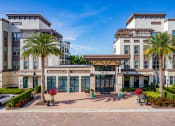 Thumbnail 2 of 35 - a large building with palm trees in front of it