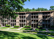 Thumbnail 5 of 26 - A large apartment complex with a green lawn in front at Winchell Way Apartment , Kalamazoo, 49008