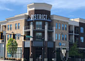Thumbnail 46 of 46 - a building with a sign on top of it on a city street